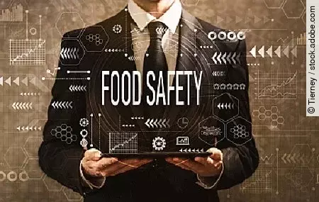 Food safety with businessman holding a tablet computer