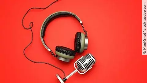 Headphones with microphone on color background