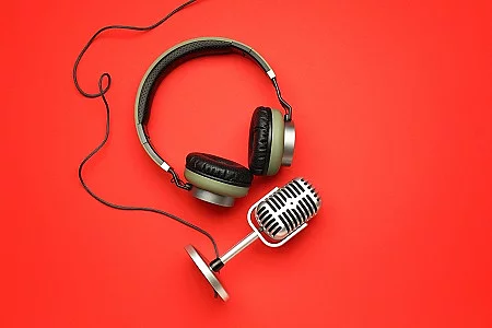 Headphones with microphone on color background