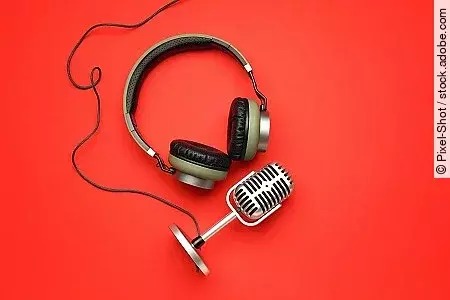 Headphones with microphone on color background