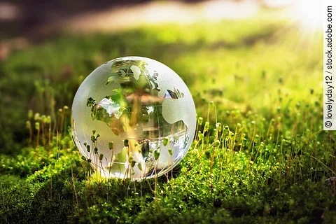 globe glass on grass with sunshine. environment concept