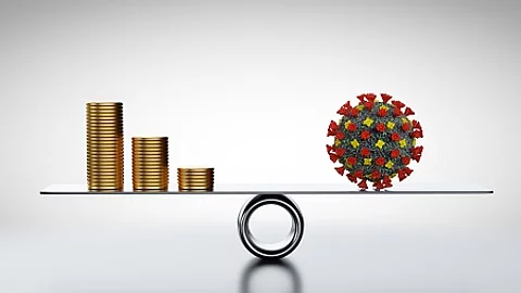 Coins, money and COVID-19 on scale. Concepts of economics against coronavirus