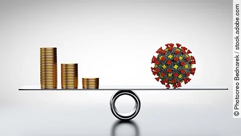 Coins, money and COVID-19 on scale. Concepts of economics against coronavirus Coins, money and COVID-19 on scale. Concepts of economics against coronavirus