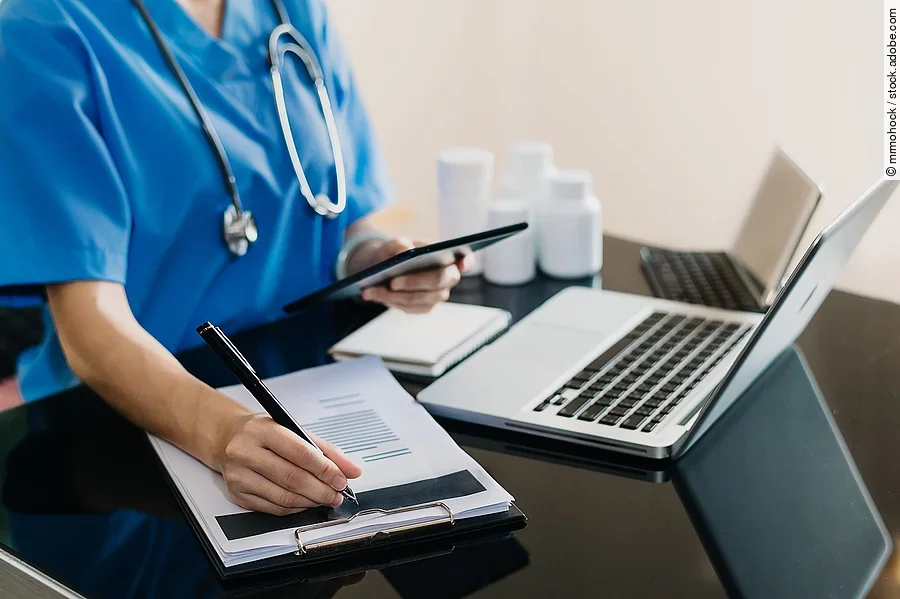 Eine Person sitzt an einem Schreibtisch.