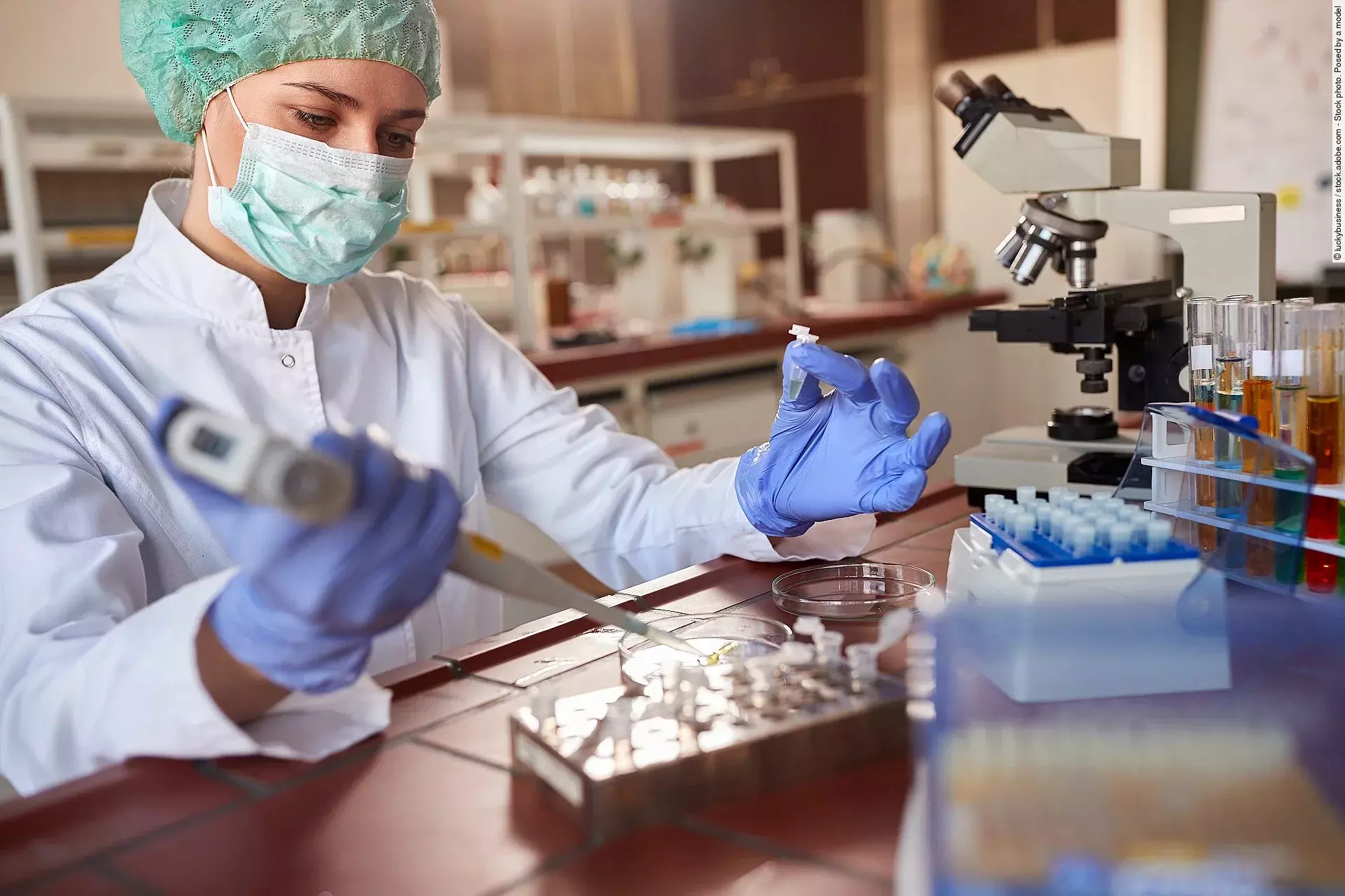 Eine Person arbeitet in einem Labor mit einer Pipette.