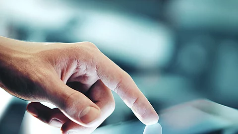 Eine Hand bedient ein Touchpad.