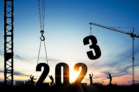 Silhouette of construction worker with crane and cloudy sky for 