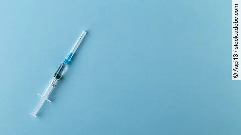 Syringe on a blue background