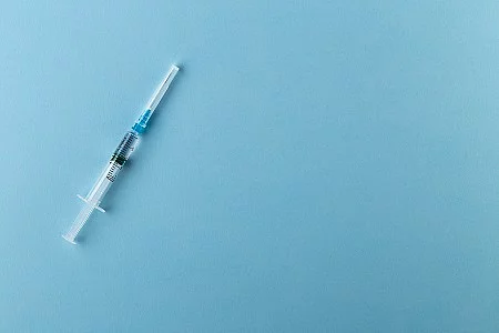 Syringe on a blue background