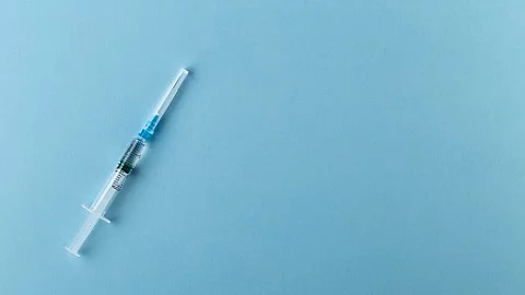 Syringe on a blue background