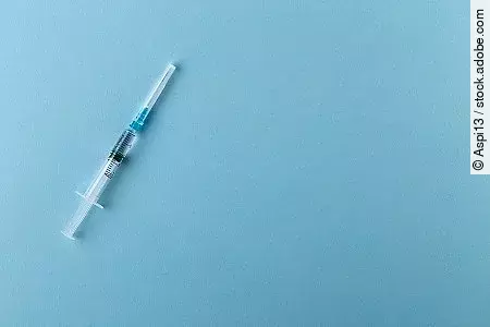 Syringe on a blue background