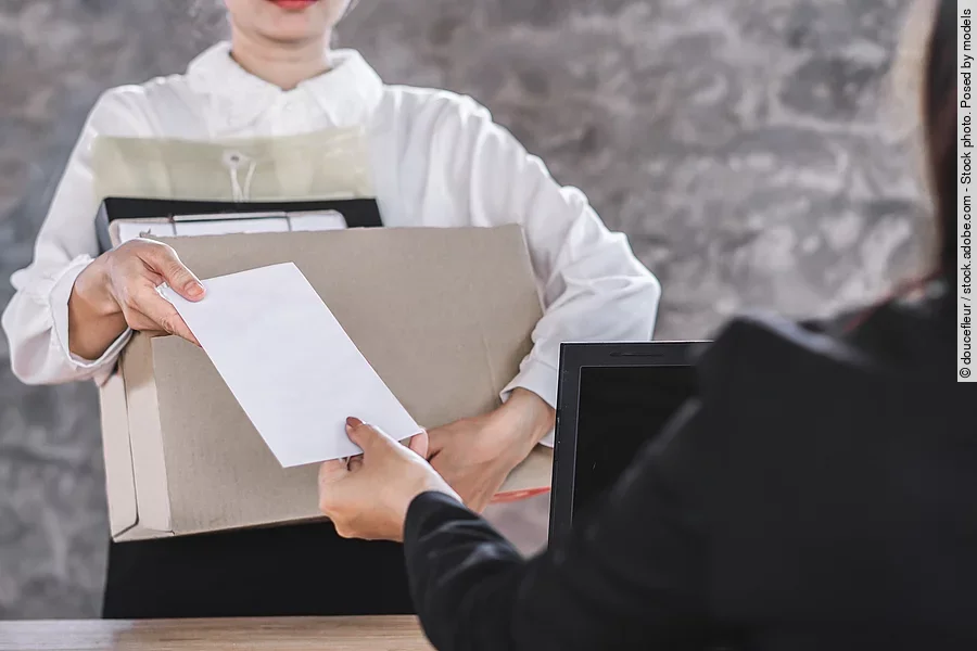 female worker hand giving resignation latter to boss quitting a job 