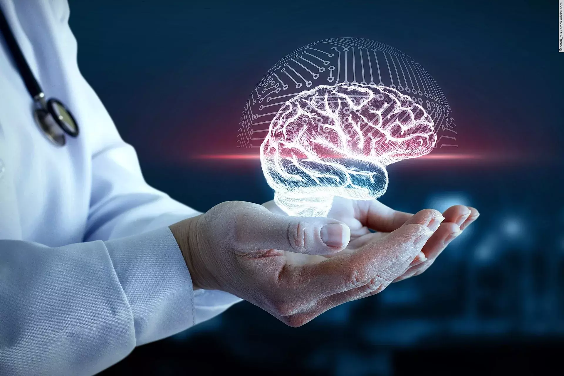 Hände von einer Person mit weißem Kittel halten ein virtuelles Gehirn fest