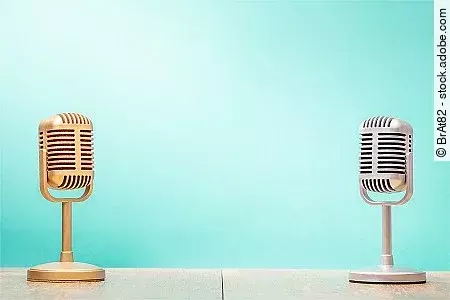 Golden and silver retro microphones on table front gradient mint green background. Vintage old style filtered photo