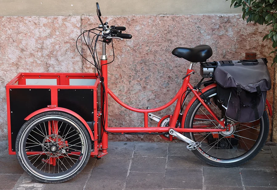 tricycle bicycles for the elderly Seitliche Ansicht von einem roten Lastenrad.
