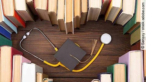 Medical degree education concept - stack of books in heart shape