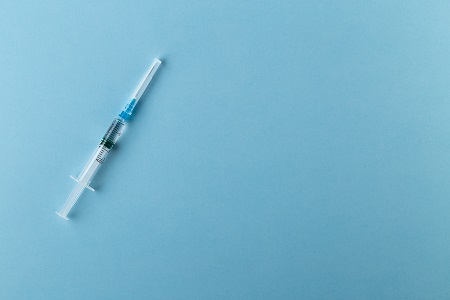 Syringe on a blue background