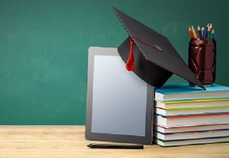 Online education. Distance learning at home. Tablet and stack of