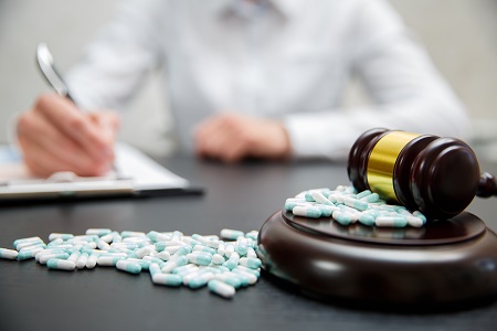 Medicine law concept. Judges gavel with pills