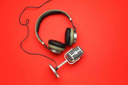 Headphones with microphone on color background